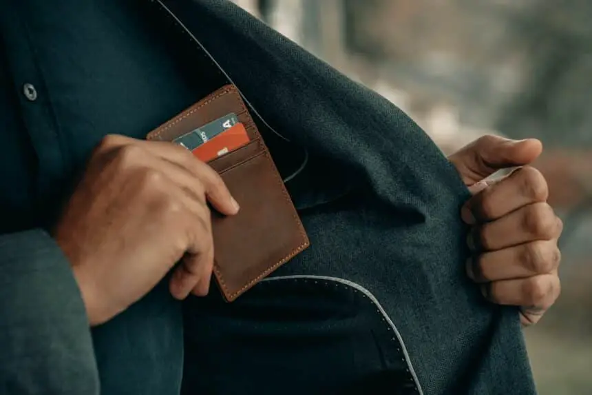 a man holding a wallet in his pocket