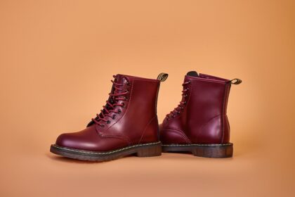 a pair of red boots on a brown background